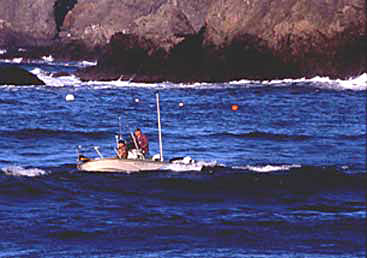 Ocean boat and crab fishermen in rough water with breaking waves of ocean