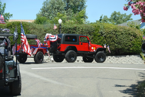 jeep and trailer decorated with flags in Independence Day parade