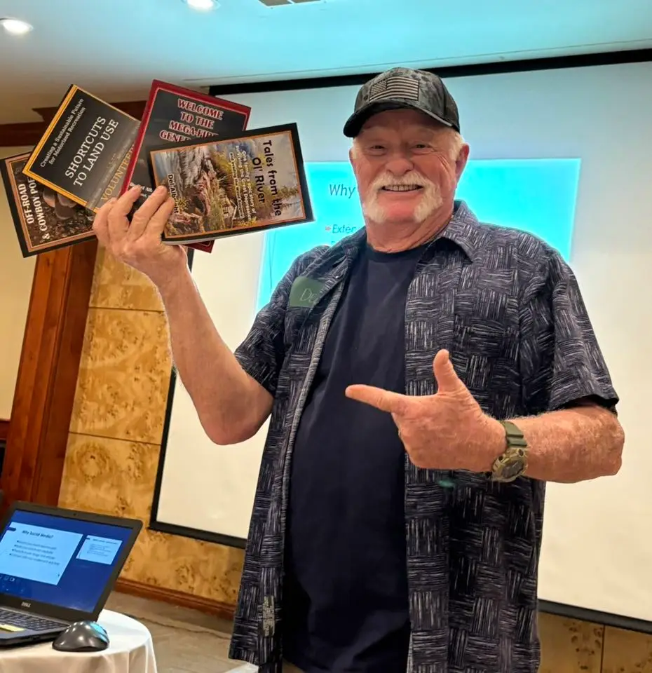 Del Albright holding his books