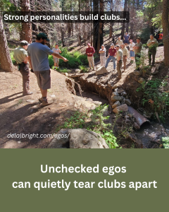 Volunteers in field discussing work project with out egos